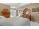 Spacious bedroom showcases a large dresser, a comfy bed, and an open en-suite bathroom entry at 5076 Nw 21St Loop, Ocala, FL 34482