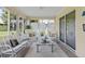Sunroom showcasing seating area with views of the outdoors, decorative lattice, and sliding glass doors at 5076 Nw 21St Loop, Ocala, FL 34482