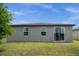 Lush backyard offers a serene setting with a well-manicured lawn and patio, perfect for outdoor enjoyment at 523 Tortugas St, Haines City, FL 33844