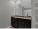 Bathroom featuring a dual sink vanity with dark cabinets and granite countertops at 523 Tortugas St, Haines City, FL 33844