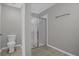 Well-lit bathroom with a tiled floor, glass-enclosed shower, and a modern toilet at 523 Tortugas St, Haines City, FL 33844