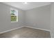 Cozy bedroom with neutral walls, tile floors, and a window with natural lighting at 523 Tortugas St, Haines City, FL 33844