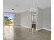 Neutral-toned living area featuring tile flooring, natural light, and a glass sliding door to the backyard at 523 Tortugas St, Haines City, FL 33844