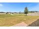Backyard view with green grass, vinyl fence, and paver patio at 531 Tortugas St, Haines City, FL 33844