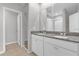 Bathroom features a double granite vanity, white cabinetry, and walk-in shower at 531 Tortugas St, Haines City, FL 33844