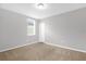 Bedroom with neutral walls, carpeting, and a large window providing natural light at 531 Tortugas St, Haines City, FL 33844