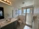 Updated bathroom with walk-in shower and tile flooring at 5604 Loma Vista W Dr, Davenport, FL 33896