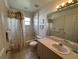 Neutral bathroom featuring a shower-tub combo and single sink vanity at 5604 Loma Vista W Dr, Davenport, FL 33896