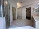 Bright bathroom with a glass shower, tile floors and direct access to a bedroom and toilet at 5604 Loma Vista W Dr, Davenport, FL 33896
