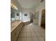 Bright primary bathroom with a large soaking tub and a walk-in shower at 5604 Loma Vista W Dr, Davenport, FL 33896