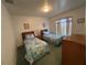 Bedroom with two twin beds, green carpet, and natural light at 5604 Loma Vista W Dr, Davenport, FL 33896