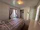 Bedroom featuring a Queen size bed, closet, and chest of drawers at 5604 Loma Vista W Dr, Davenport, FL 33896