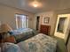 Bright bedroom featuring twin beds, carpet floors, a window, and a closet at 5604 Loma Vista W Dr, Davenport, FL 33896