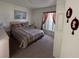 Comfortable bedroom with Queen size bed and two end tables at 5604 Loma Vista W Dr, Davenport, FL 33896