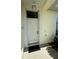 View of the entryway featuring a white front door with a window and decorative light fixture at 5604 Loma Vista W Dr, Davenport, FL 33896