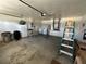 Large garage with laundry machines, storage, and a ladder, offering functional space at 5604 Loma Vista W Dr, Davenport, FL 33896