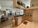 Open concept kitchen features stainless steel appliances and views of the living area at 5604 Loma Vista W Dr, Davenport, FL 33896