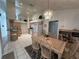 Bright kitchen and dining area with tile floors, and a decorative chandelier at 5604 Loma Vista W Dr, Davenport, FL 33896