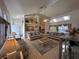 Open-concept living area featuring tile flooring, comfortable sofas, and an adjacent dining area at 5604 Loma Vista W Dr, Davenport, FL 33896