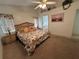 Carpeted main bedroom with a ceiling fan, natural light, and ensuite bathroom access at 5604 Loma Vista W Dr, Davenport, FL 33896