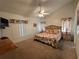 Spacious main bedroom features a ceiling fan, carpet floors, and lots of natural light at 5604 Loma Vista W Dr, Davenport, FL 33896