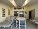 Enclosed patio featuring a dining table, lounge chairs, a ceiling fan and stylish decor at 5604 Loma Vista W Dr, Davenport, FL 33896