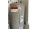 A.O. Smith water heater, energy saver, with warning labels and pipe connections, installed in utility area at 5604 Loma Vista W Dr, Davenport, FL 33896