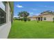 Well-maintained backyard with lush green lawn and mature landscaping at 578 Newhall Ln, Debary, FL 32713