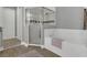 Modern bathroom featuring a glass shower, soaking tub and neutral decor at 578 Newhall Ln, Debary, FL 32713