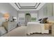A serene bedroom with a tray ceiling, two windows, and neutral furnishings at 578 Newhall Ln, Debary, FL 32713