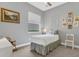 A charming bedroom with a single bed, window with blinds, and decorated with pictures at 578 Newhall Ln, Debary, FL 32713