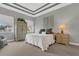 Comfortable bedroom with neutral tones, tray ceiling, and ample natural light at 578 Newhall Ln, Debary, FL 32713