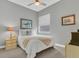 A calm bedroom featuring a comfortable bed, window with blind, and neutral wall decor at 578 Newhall Ln, Debary, FL 32713
