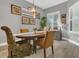 Light and bright dining room features wood floors, neutral walls, and a large window with plantation shutters at 578 Newhall Ln, Debary, FL 32713