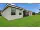 Lush green lawn surrounds the home's exterior and screened in patio at 578 Newhall Ln, Debary, FL 32713