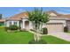 Charming home featuring a two-car garage, neutral paint, brick driveway, manicured lawn, and mature landscaping at 578 Newhall Ln, Debary, FL 32713