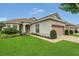 Charming home featuring a two-car garage, neutral paint, brick driveway, manicured lawn, and mature landscaping at 578 Newhall Ln, Debary, FL 32713