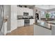 Bright kitchen features granite countertops, white cabinetry, and stainless steel appliances at 578 Newhall Ln, Debary, FL 32713