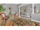 Neutral living room featuring an elegant ceiling, recessed lights, tile floor, columns, and a view to the front entry at 578 Newhall Ln, Debary, FL 32713