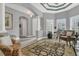 Neutral living room featuring an elegant ceiling, recessed lights, tile floor, columns, and view to front entry at 578 Newhall Ln, Debary, FL 32713