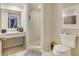 Well-lit bathroom with a clean shower, vanity, and toilet at 5833 La Costa Dr # S, Orlando, FL 32807