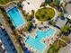 Aerial view showcasing community pools with lounge chairs and recreation area at 7789 Nemours Pkwy, Orlando, FL 32827