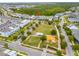 Aerial view of neighborhood and home next to green space and playground at 7789 Nemours Pkwy, Orlando, FL 32827