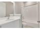 Clean, bright bathroom with white fixtures, including a bathtub, toilet, and vanity with a modern mirror at 7789 Nemours Pkwy, Orlando, FL 32827