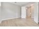 Inviting bedroom with light wood floors and neutral walls offering versatility and comfort at 7789 Nemours Pkwy, Orlando, FL 32827