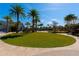 Beautiful green space and volleyball court surrounded by palm trees on a sunny day at 7789 Nemours Pkwy, Orlando, FL 32827