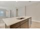 Kitchen island with stainless steel sink and dishwasher in an open floor plan at 7789 Nemours Pkwy, Orlando, FL 32827