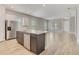 Open-concept kitchen featuring an island with a sink and stainless steel appliances at 7789 Nemours Pkwy, Orlando, FL 32827
