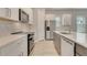 Modern kitchen featuring white cabinetry, stainless steel appliances, and a stylish backsplash at 7789 Nemours Pkwy, Orlando, FL 32827