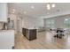 Open concept living room and kitchen with wood floors and natural light at 7789 Nemours Pkwy, Orlando, FL 32827